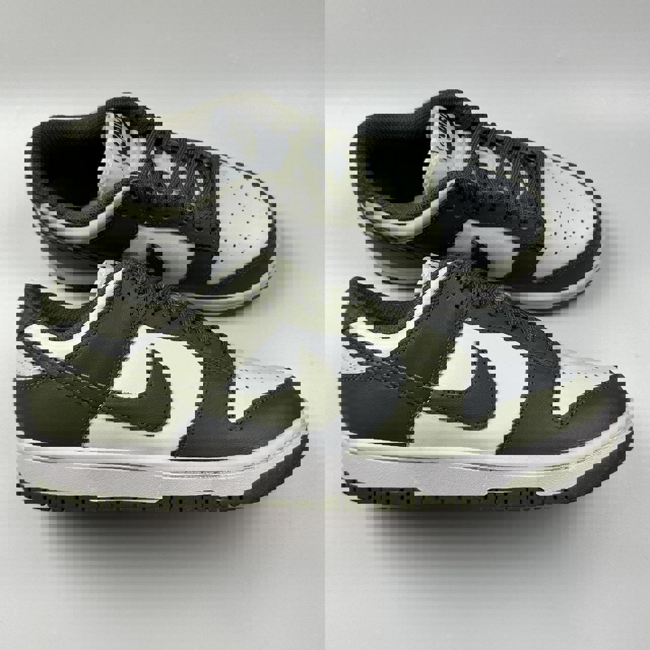 Nike Dunk Low in olive green and white.