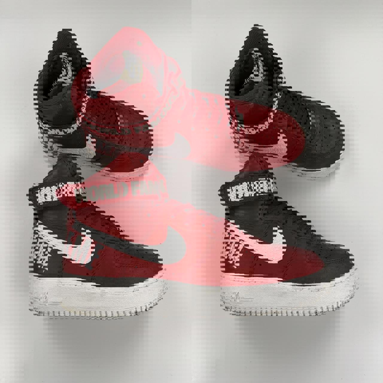 Supreme x Nike Air Force 1 High World Famous sneakers in red.