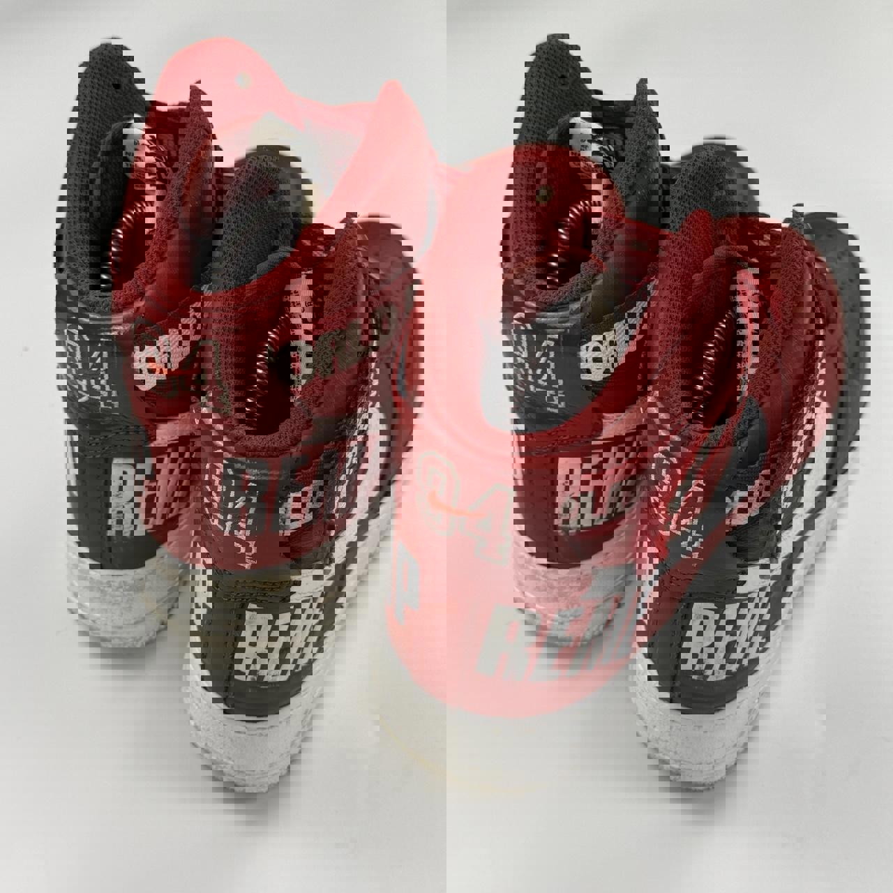 Supreme x Nike Air Force 1 High World Famous sneakers in red.