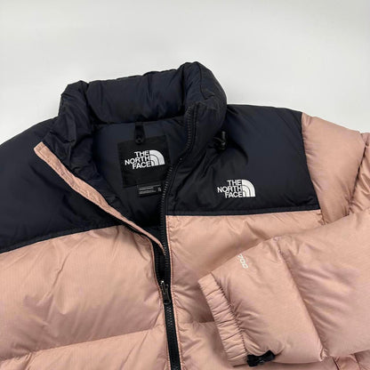 The North Face TNF 1996 Nuptse Puffer Jacket in light pink and black.