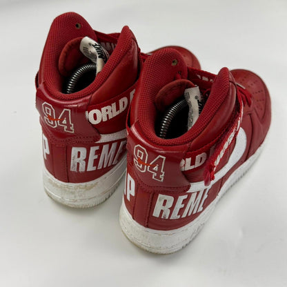 Supreme x Nike Air Force 1 High World Famous sneakers in red.