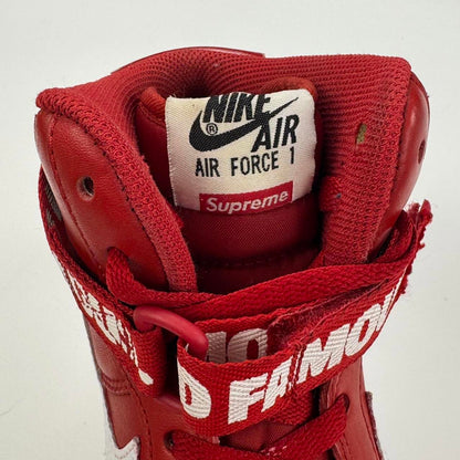Supreme x Nike Air Force 1 High World Famous sneakers in red.