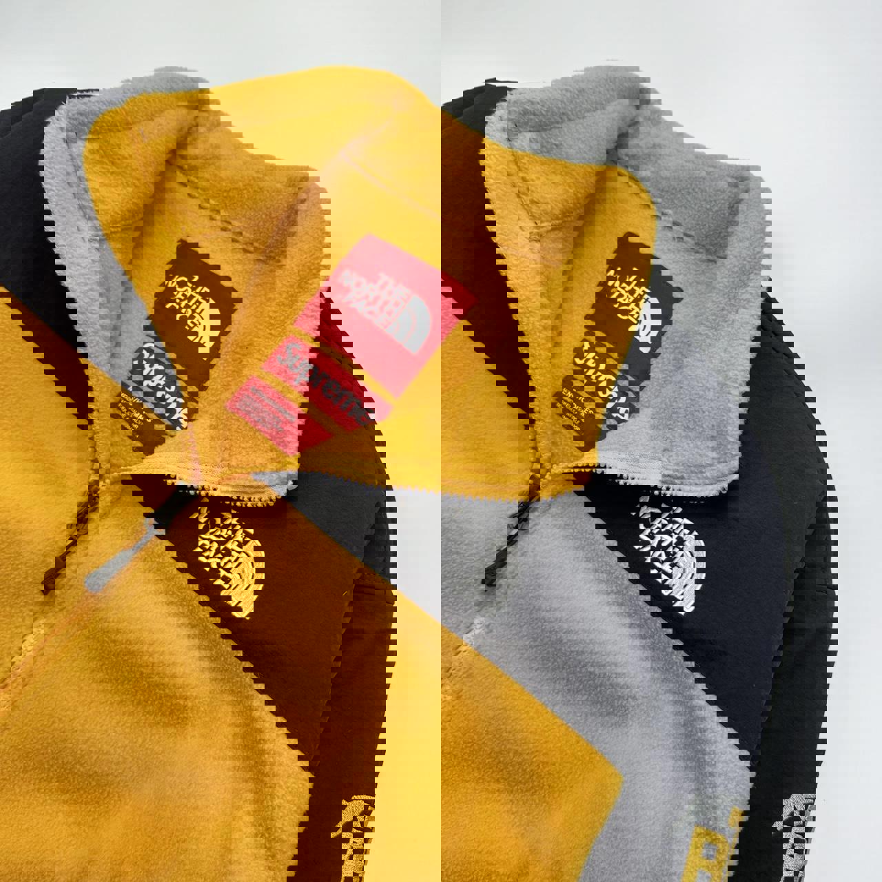 Supreme x The North Face TNF RTG Fleece Jacket in yellow and black.